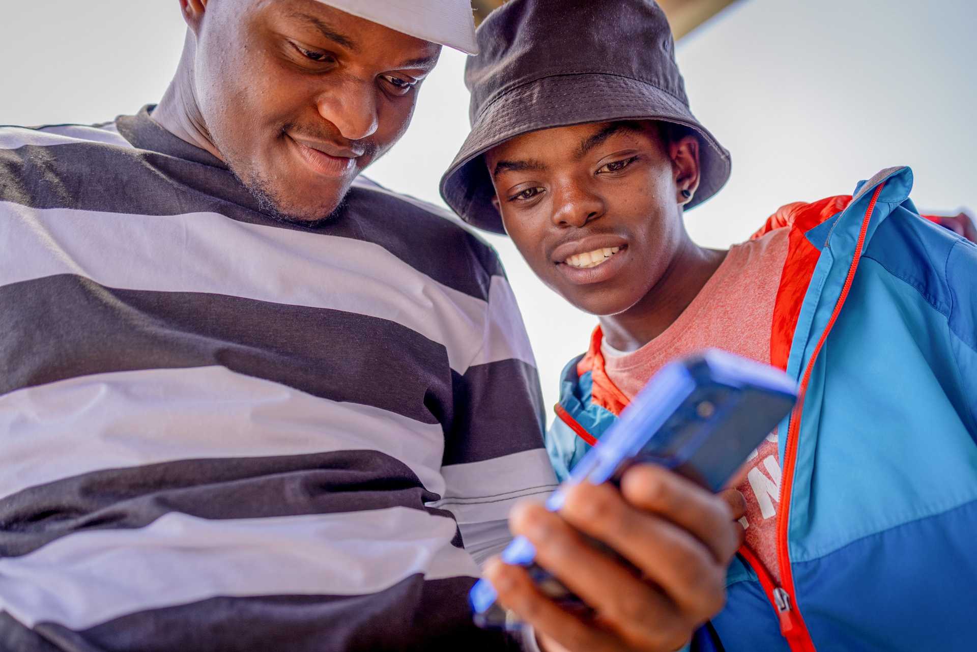 Two young people looking at a mobile phone in Johannesburg South Africa 